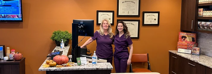 Chiropractic Troy MI Office Assistants Behind Desk Contact Us